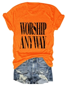 Detail of orange crew neck T-shirt with black Worship Anyway print and denim shorts