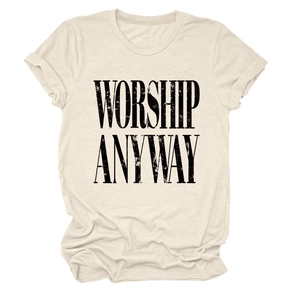 Detail view of the WORSHIP ANYWAY black lettering printed on a cream cotton short sleeve T-shirt