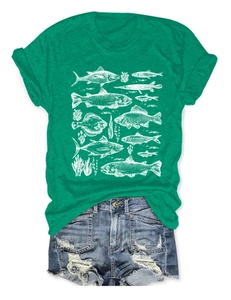 Detail of green crew neck T-shirt featuring white fish and seagrass print with denim shorts