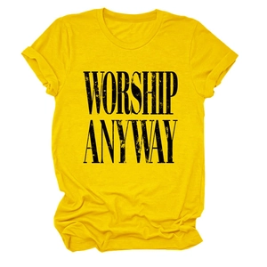Detail of WORSHIP ANYWAY bold black lettering on a yellow crew neck cotton t-shirt