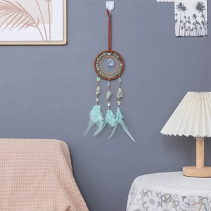 Handmade turquoise dreamcatcher wall hanging with feathers and crystals for home decor