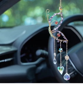 Detail of butterfly suncatcher with colorful natural stones and crystal droplets