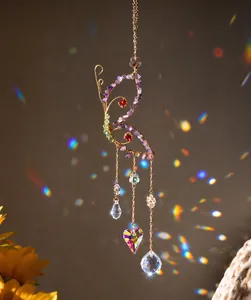 Macro detail of butterfly suncatcher with purple crystal gravel and prism pendants