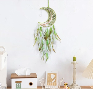 Detail of moon-shaped dream catcher with crystal tree of life and colorful feathers