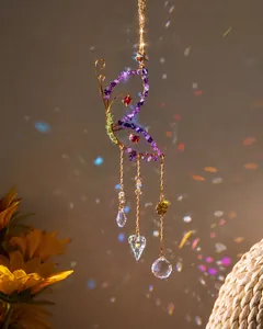 Macro detail of butterfly suncatcher with purple amethyst stones and crystal prisms