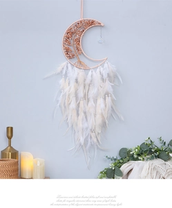 Detail of crescent moon dream catcher with tree of life stones and white soft feathers