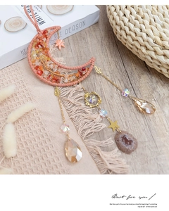 Detail of moon dreamcatcher with orange natural stones and golden star pendants