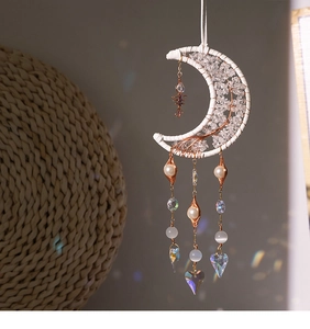 Detail of tree of life suncatcher with moon-shaped dreamcatcher and crystal prism beads