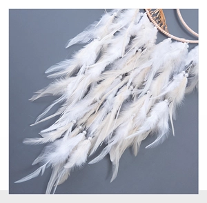 Detail of white feathers and pearl beads on a Tree of Life moon dream catcher chime