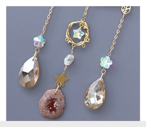 Macro detail of suncatcher with champagne teardrop crystal and golden chain ornament