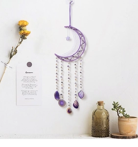 Detailed view of handmade purple crescent moon dream catcher with amethyst crystals