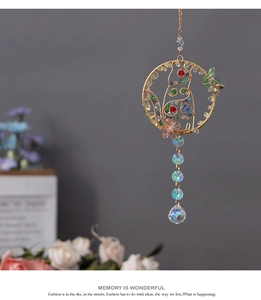 Detail of handmade crystal suncatcher cat with gold wire weaving and rainbow beads
