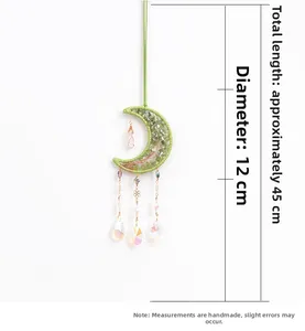 Detailed view of moon suncatcher with green stones and life tree crystal pendant
