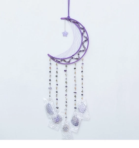 Detailed view of handmade purple moon dreamcatcher with amethyst stones and hanging beads
