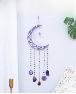 Detailed view of purple crescent moon dreamcatcher with hanging amethyst stones for wall decor