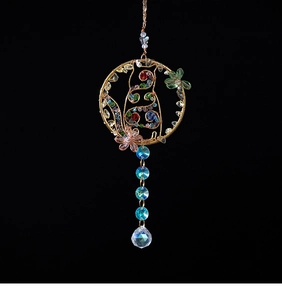 Detail of handcrafted crystal cat dreamcatcher car pendant with colorful beads and wire
