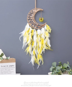 Detail of bohemian moon dreamcatcher with yellow feathers and crystal tree of life