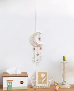 Detail of moon-shaped suncatcher with life tree crystals and heart pendants