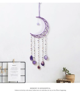 Close-up of purple moon dreamcatcher with amethyst stones and beaded tassels hanging on wall
