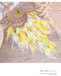 Macro detail of moon dream catcher with yellow crystals and tree of life weaving