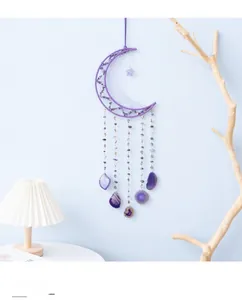 Macro shot of purple moon dreamcatcher with amethyst stones and hanging crystals