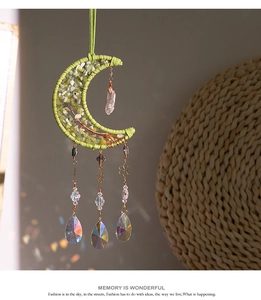 Detail of brass crescent moon tree of life suncatcher with green stones and crystals