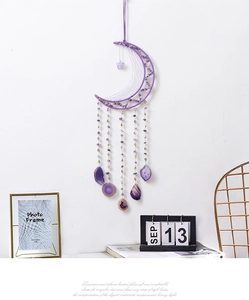 Detail of purple moon dreamcatcher with amethyst stones and hanging agate slices