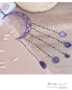 Close-up of purple moon dreamcatcher with natural amethyst stones and agate slices