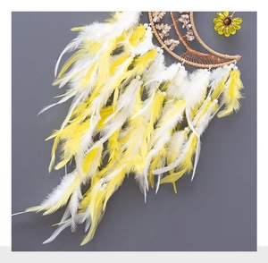 Close-up of yellow moon dreamcatcher with sunflower, citrine stones and soft feathers