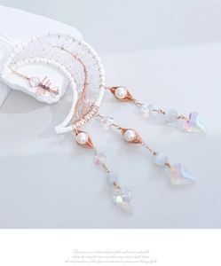 Detail of tree of life suncatcher with crescent moon frame and iridescent heart pendant