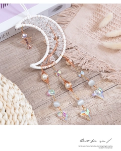 Detail of moon-shaped tree of life suncatcher with crystal beads and heart prism