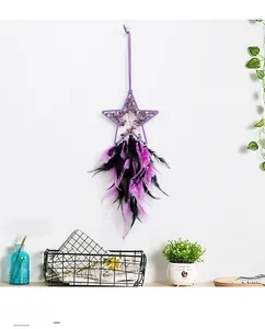 Detail of star-shaped dreamcatcher with amethyst tree of life and black purple feathers