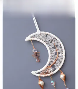 Detail of moon-shaped suncatcher with Tree of Life wire wrap and crystal stones