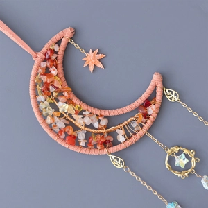 Bohemian moon suncatcher with orange and white crystals and metallic leaf pendants