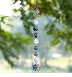Macro detail of bird-shaped wire wrap and colorful crystal stones on hanging ornament