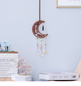 Close-up of crescent moon tree of life wall hanging with natural red jasper stones