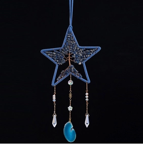 Dettaglio dell'acchiappasogni a stella blu con albero della vita e ciondolo in agata