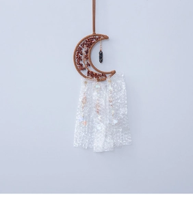 Detail of moon shaped Tree of Life wall hanging with red crystals and white tassels