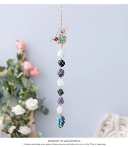 Detail of handmade wire-wrapped bird ornament with seven chakra natural healing stones