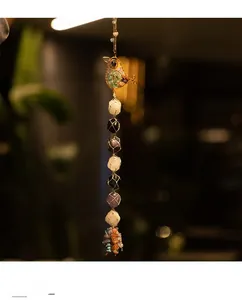 Detailed wire-wrapped bird charm with vertical natural gemstone chakras and crystal clusters