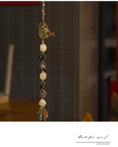 Detailed wire-wrapped bird charm with assorted natural crystal hanging stones for decor
