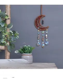 Macro detail of moon-shaped crystal dreamcatcher wall decor with snowflake pendant