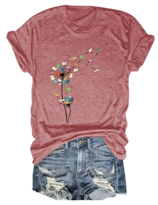 Close-up of dandelion book graphic on a crew neck short sleeve tee with denim shorts