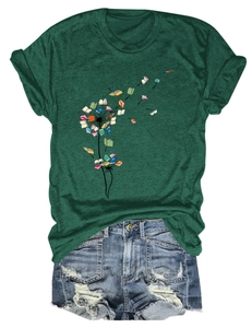 Flat lay of a green T-shirt with dandelion book print and distressed denim shorts