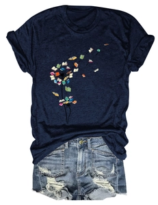 Detail of navy t-shirt with book dandelion print paired with ripped denim shorts