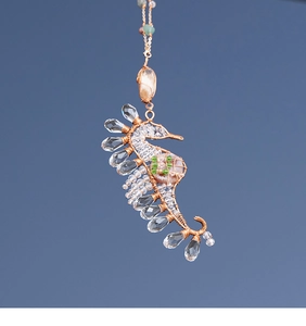 Detailed handmade bronze wire-wrapped seahorse pendant with crystal beads and pink gemstone