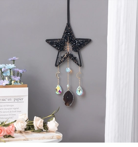 Detail of star-shaped Tree of Life suncatcher with black woven rope and colorful crystals