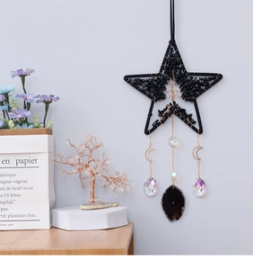 Detailed close-up of tree of life star suncatcher with moon and agate slice hanging decor