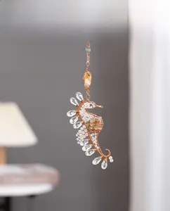 Detail of handmade seahorse ornament with gold wire, crystals and colorful beads