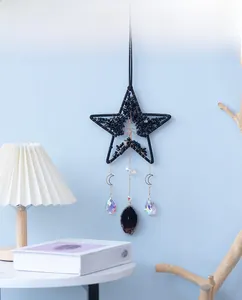 Detail of star-shaped sun catcher featuring a copper tree of life and agate stone pendant